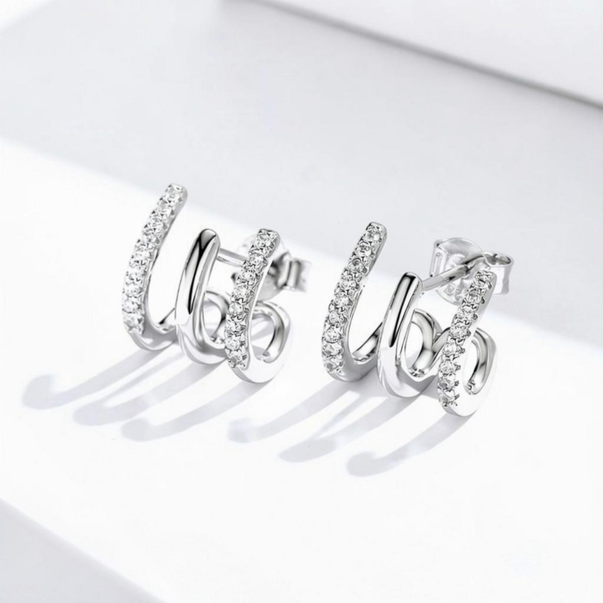 arcana three-layer sterling silver earrings with sparkling gem accents in a geometric heart-inspired design